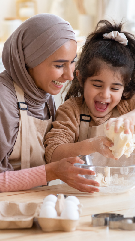 Thyroid Health Image Thyroid Health Image Alt Text; Young mother and daughter baking in the kitchen