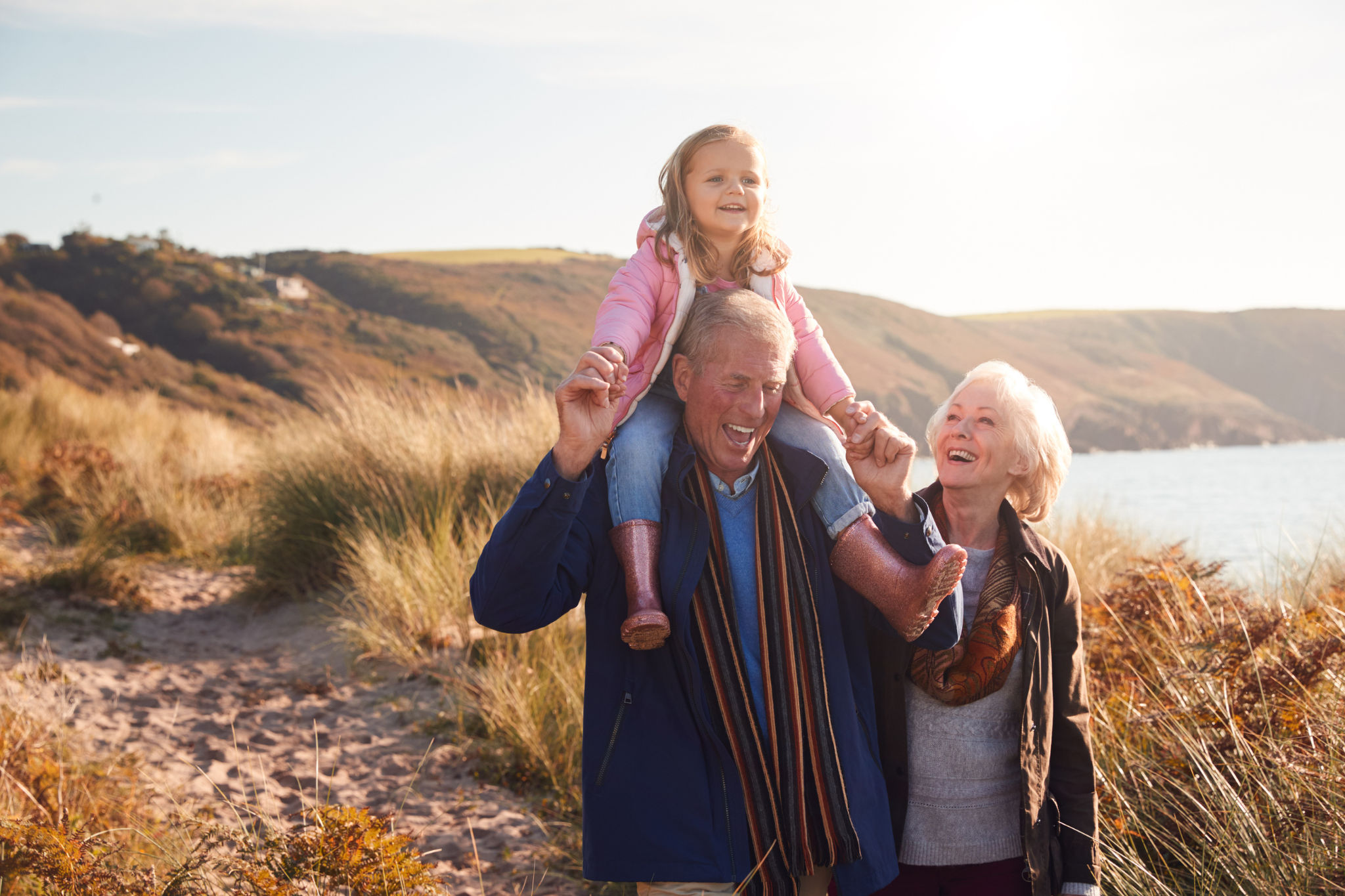 Heart Health Image Alt Text - Elderly Grandparents on a walk with young granddaughter.