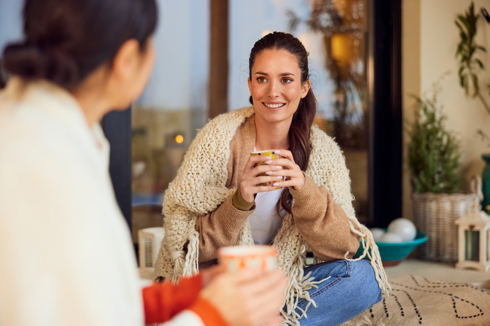 Tumour Associated Markers Image Alt Text: Two young woman talking over coffee