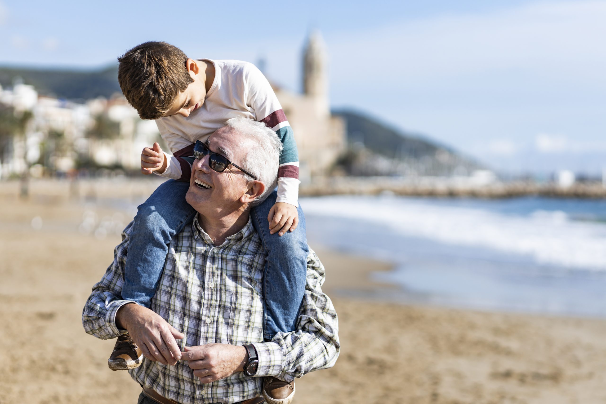 Old Man With Grandson On Shoulders